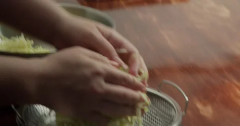 View back on the peel the zucchini. 4K close-up: A chef transfers sliced Stock Footage 324517299