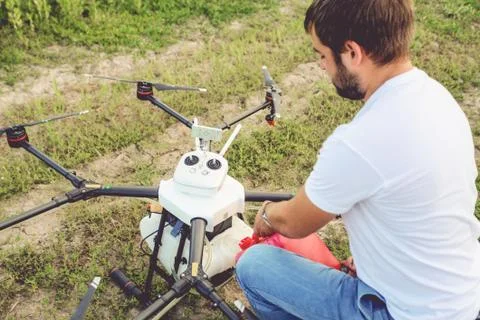 View from the back process of preparing agro drones for irrigation. Stock Photos