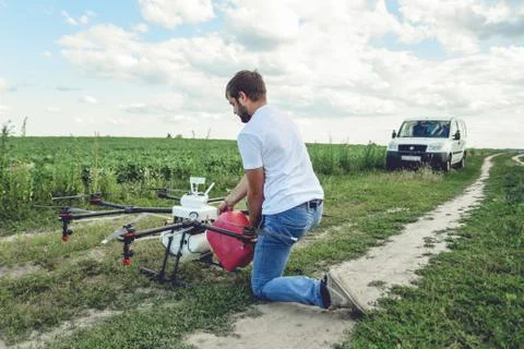 View from the back process of preparing agro drones for irrigation. Stock Photos