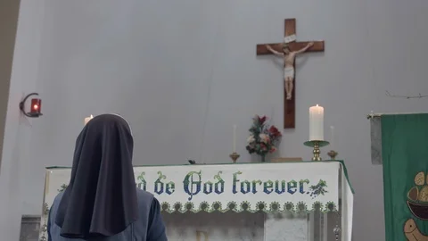 View from back of religious sister praying at altar. Stock Footage 99332619