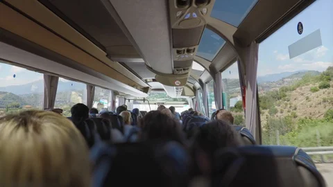 View from the back row inside of the modern bus full of people all in darkness. Stock Footage 94120878