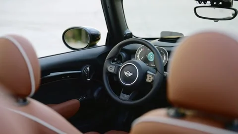View from back seat of electric Mini Cooper Convertible interior with roof down Video stock 261247542
