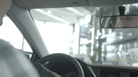 View from the back seat of a man driving a luxury car with leather salon. Stock Footage 101104536