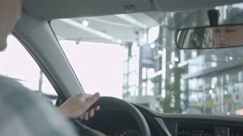 View from the back seat of a man driving a luxury car with leather salon. Stock Footage 101104540
