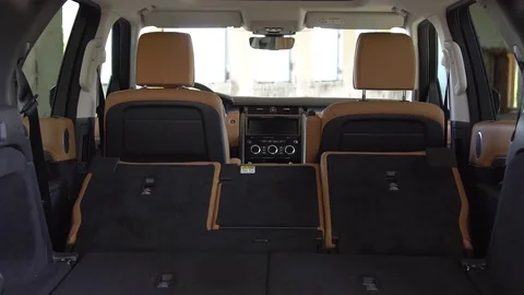 View of back seats automatically unfolding inside mini van vehicle. Stock Footage 80979117