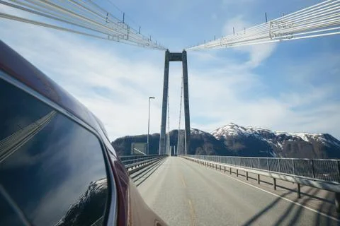 View back from side of car, driving on modern bridge at sunny day with beautiful Stock Photos