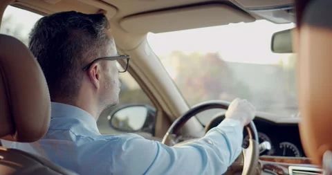 View from the back sit on the male driver in glasses. Caucasian businessman Видео 141348485