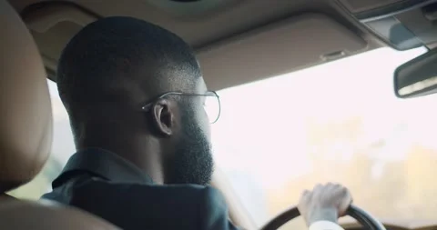 View from the back sit on the male driver in glasses. African American Stock Footage 141349590