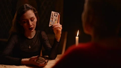 View from back of unrecognizable client to mysterious fortuneteller talking to Stock Footage 274451482