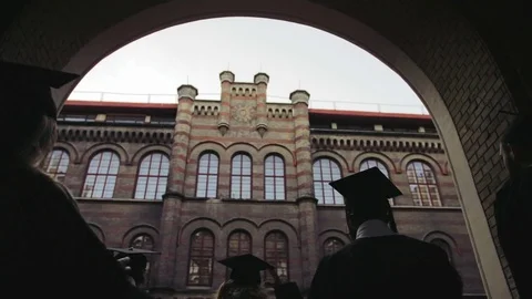 View from the back on walking graduates through the passage and tossing their Stock Footage 83602797