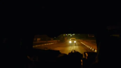 View from back window of car leaving Zambia airport at night, going to Stockbeeldmateriaal 237980489