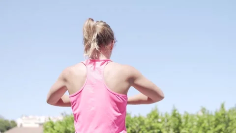 View from the back, woman doing gymnastics against the background of blue sky Stock Footage 275510225