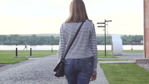 View from the back of a young beautiful brunette girl with medium length hair Stock Footage 77576294