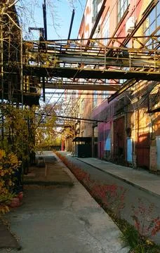 View of the backyard and the facade of the old factory Stock Photos