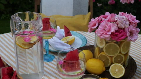 A view of the backyard garden table setting in a yellow palette with lemons, gar Stock Footage 279012371