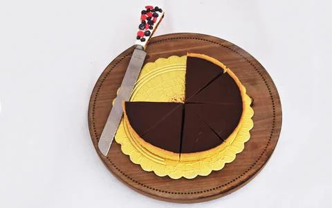 View of baked cut cake on a table and knife Stock Photos