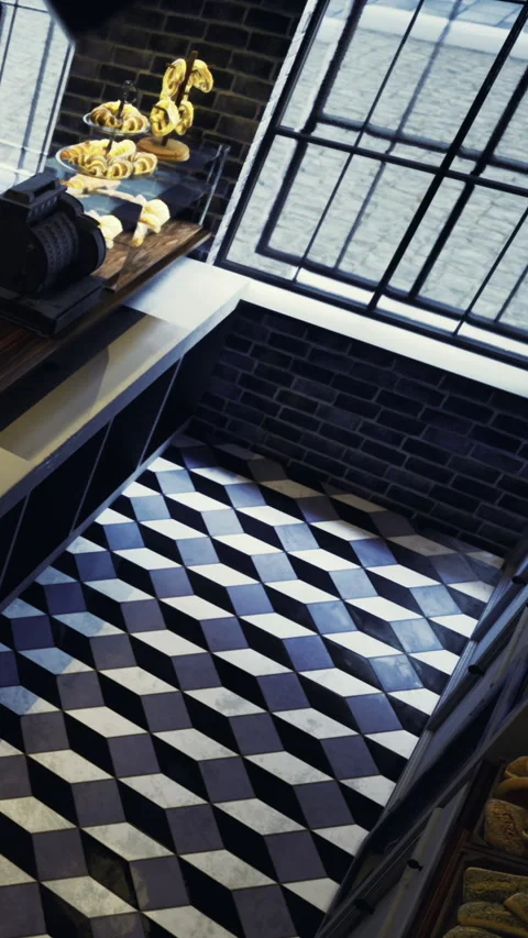 View of a bakery floor with black and white tiles and bread on display Stock Footage 331670618