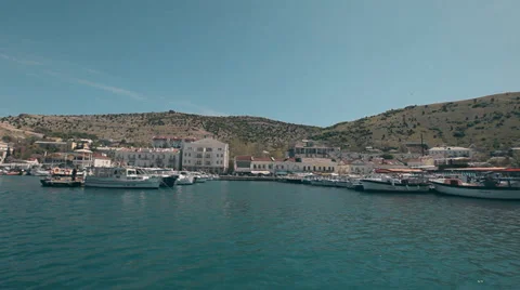 View Balaklava with a yacht that comes into the bay Stock Footage