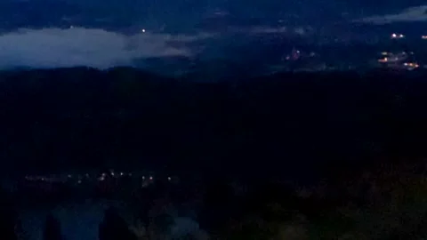 View from the balcony of the night city, small fog mountains Stock Footage 254151295