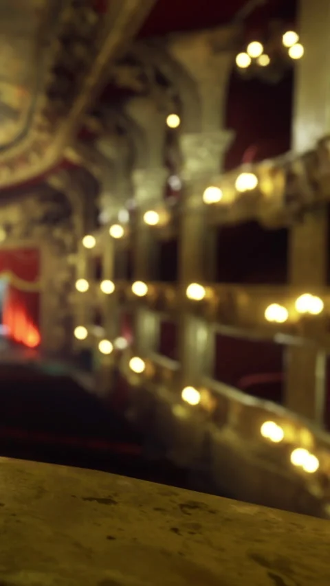 View from balcony in theater during a performance with lights on the walls Stock Footage 334175012