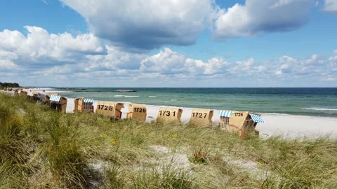 View of Baltic Sea beach in Probstei with hooded beach chairs Stock Footage 134951693