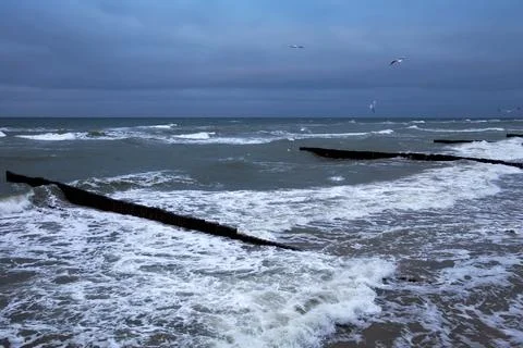 View of the Baltic Sea in the winter during a strong wind in overcast weather Stock Photos