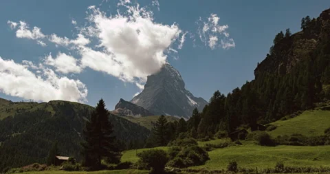 View of banner shaped clouds on Matterhorn peak from Blatten meadows Stock Footage 158493550