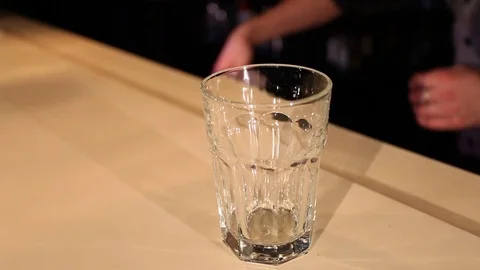 View of barman puts ice cubes in cocktail glass Stock Footage 72802560