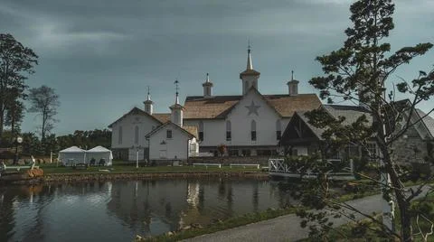 View of Barns and a Pond and Other Buildings Stock Photos