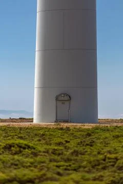 View from the base of the tower of a wind turbine, with access door Stock Photos