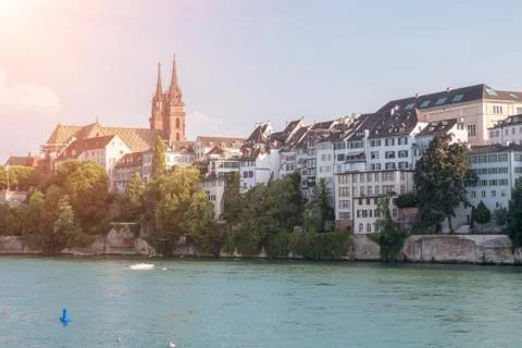 View on Basel city and river Rhine, Switzerland. People swim in water Stock Photos