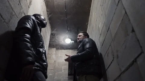 View of a basement with the ceiling in the cobweb, caucasian guy and black guy Video stock 171346839