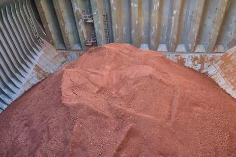 View of bauxite in bulk inside cargo hold of bulk carrier Stock Photos