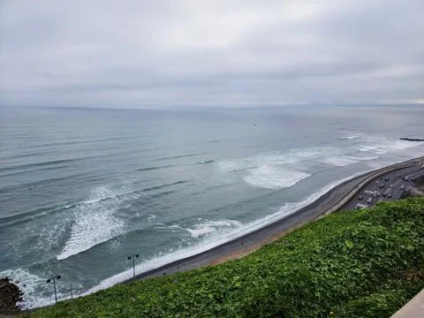 View of the bay from a cliff with many waves, beaches, and plants Stock Photos