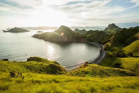 View of the bay surrounded by green-capped mountains of Padar island Stock Photos