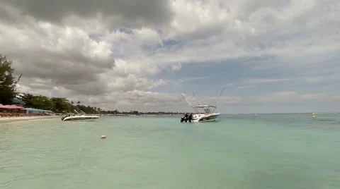 View of a beach and crystal clear waters on a sunny day, Mauritius Stock Footage