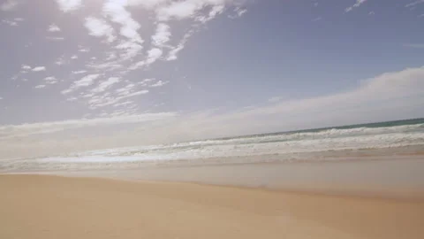 View of a beach and ocean in Australia with bright natural lighting. Wide shot o Stock Footage 199458619