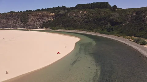 View of beach and river going into the sea with a hill backdrop. Stock Footage 150841854