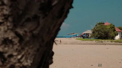 View of a beach from behind a rock Stock Footage 63529133