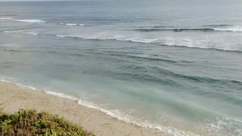 View of the beach with crashing waves from a high angle Stock Footage 274725485