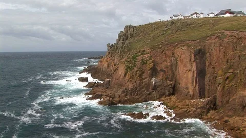View of beach homes on granite cliff top in Cornwall, England Stock Footage 101490568