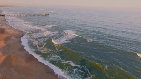 View of the beach with the ocean and sky at sunset. Stock Footage 77506969