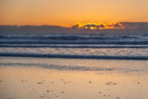 View of Beach Sand with Sunset Blur in the background Stock Photos