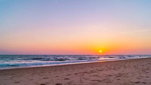 View from the beach on the setting sun Stock Photos