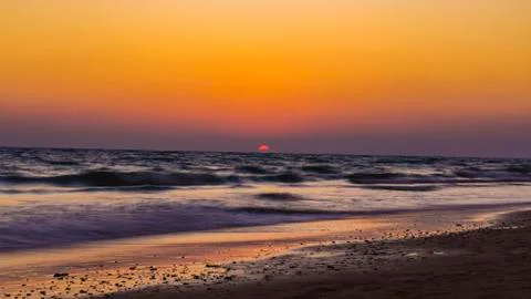 View from the beach on the setting sun Stock Photos