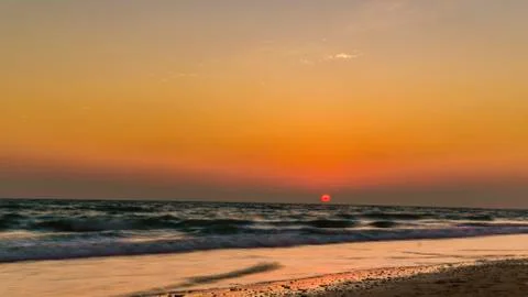 View from the beach on the setting sun Stock Photos