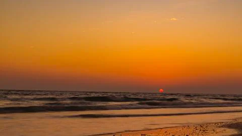 View from the beach on the setting sun Stock Photos
