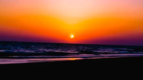 View from the beach on the setting sun Stock Photos