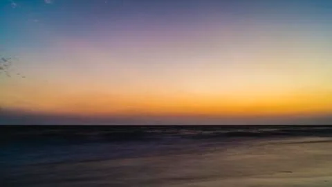 View from the beach on the setting sun Stock Photos