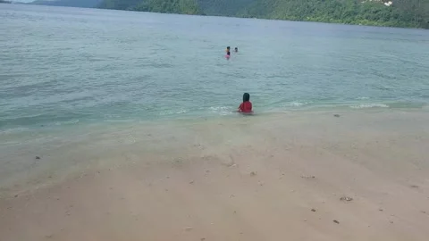 A view on the beach with some people playing on the beach 스톡 동영상 293947954